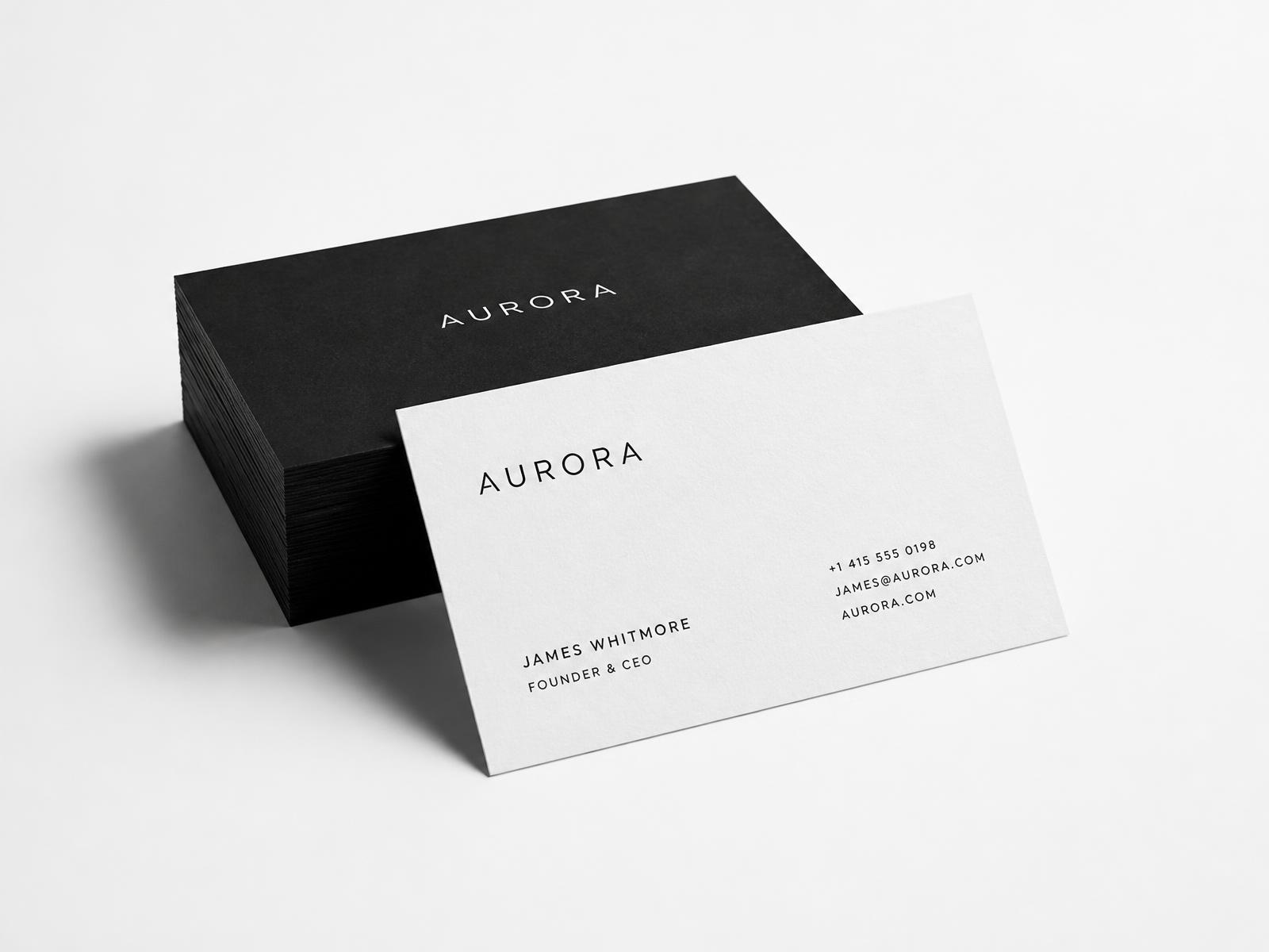 Minimal black and white business cards stacked on a white surface